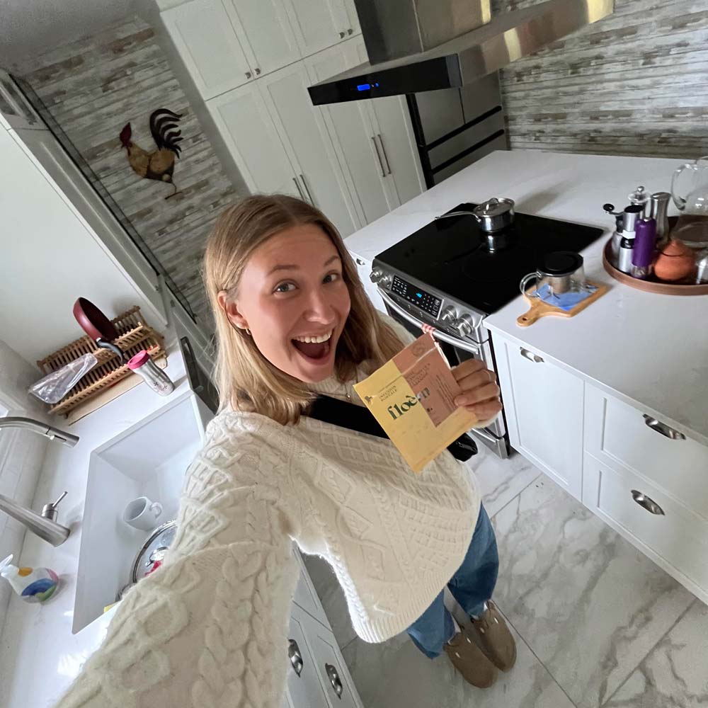Cliente Floèm qui tient un sac de thé dans sa main dans une cuisine